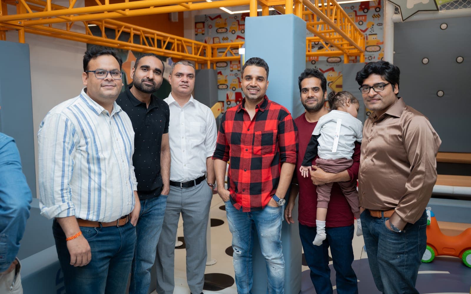 Group of dads posing together in the play zone